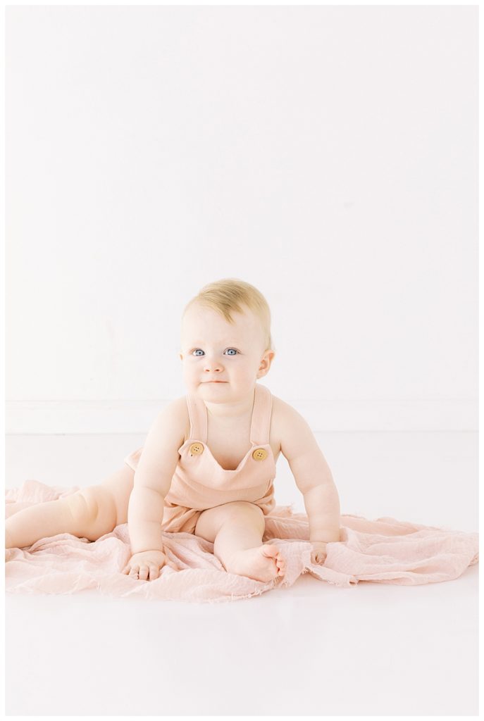 One year old baby in pink romper Milestone Session with Halleigh Hill