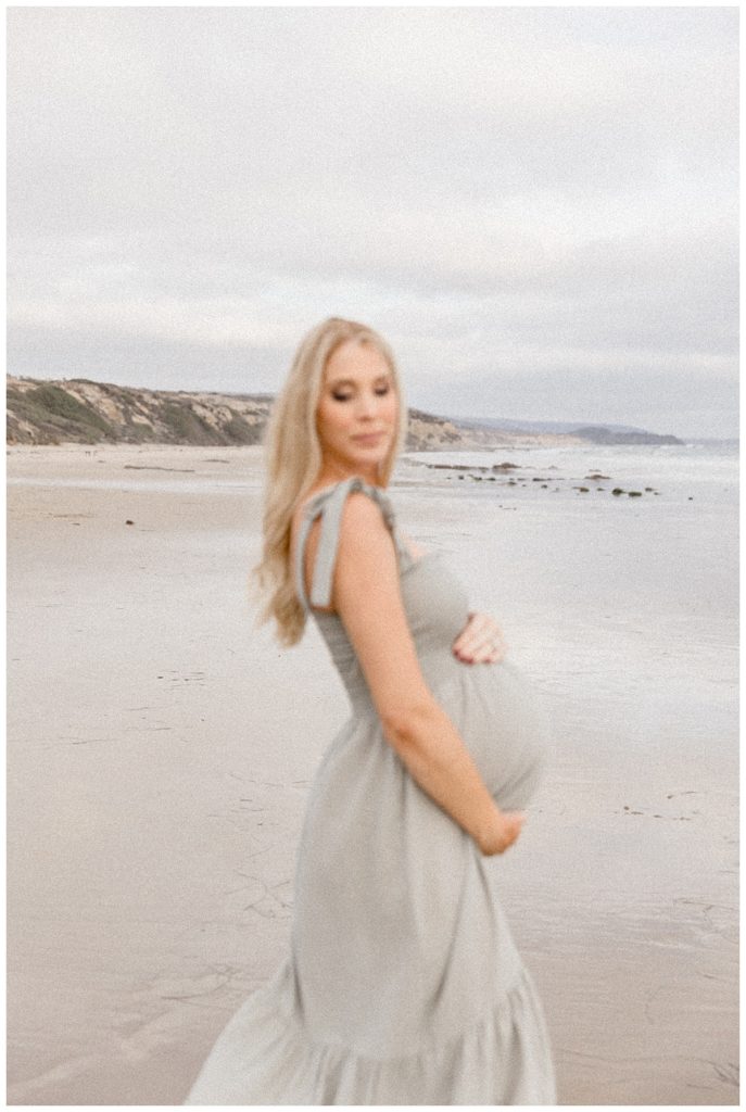 Pregnant woman on a beach alone during her Newport Beach Maternity Session
