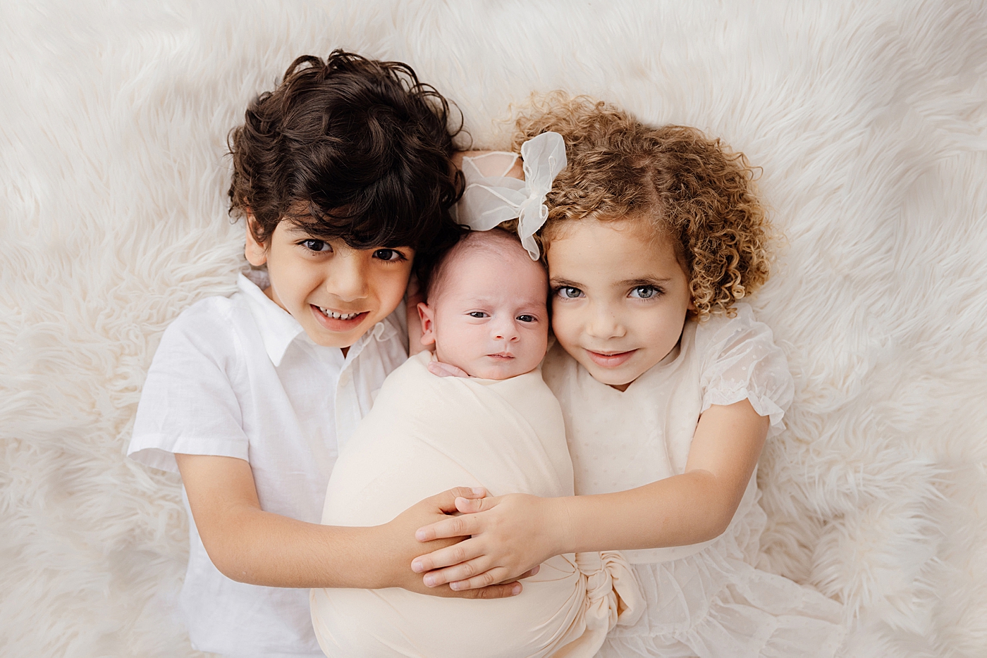 Big brother and sister with their new baby | Image by Halleigh Hill